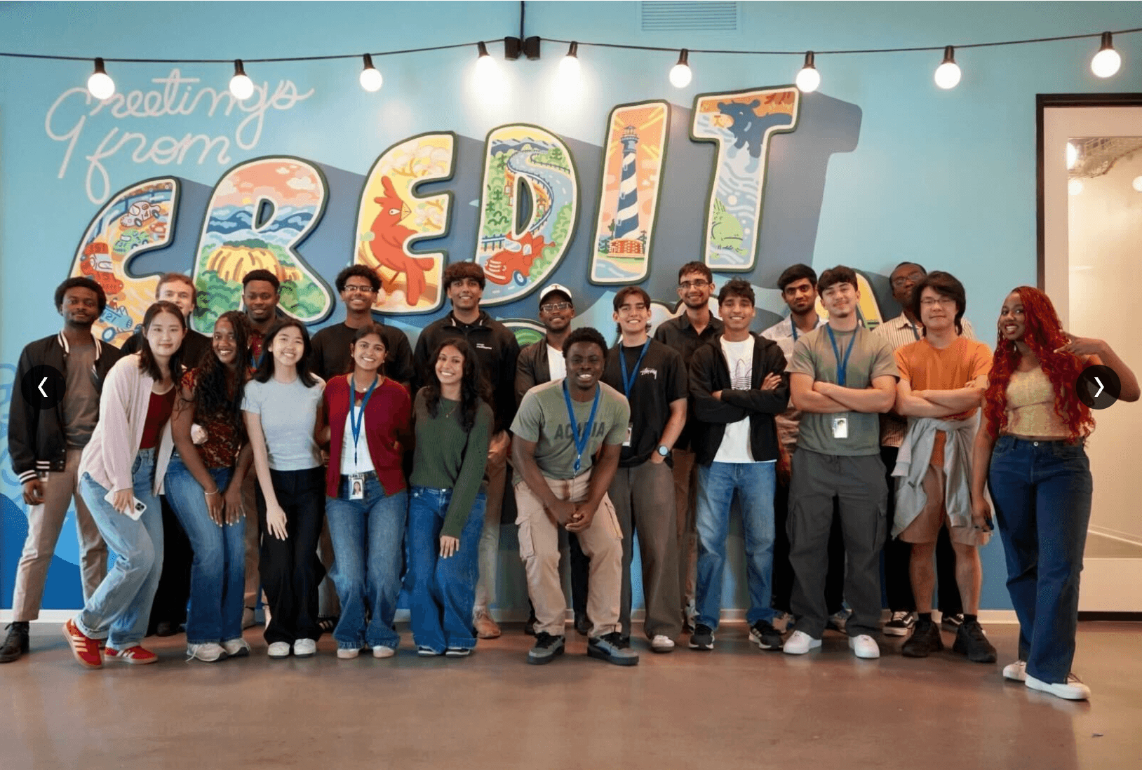 Pablo with the Credit Karma internship cohort in front of a colorful Credit Karma mural.
